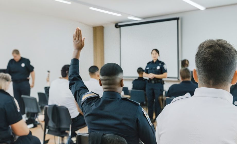 Police,Officers,In,Training,Room,Raising,Hand,To,Ask,Query